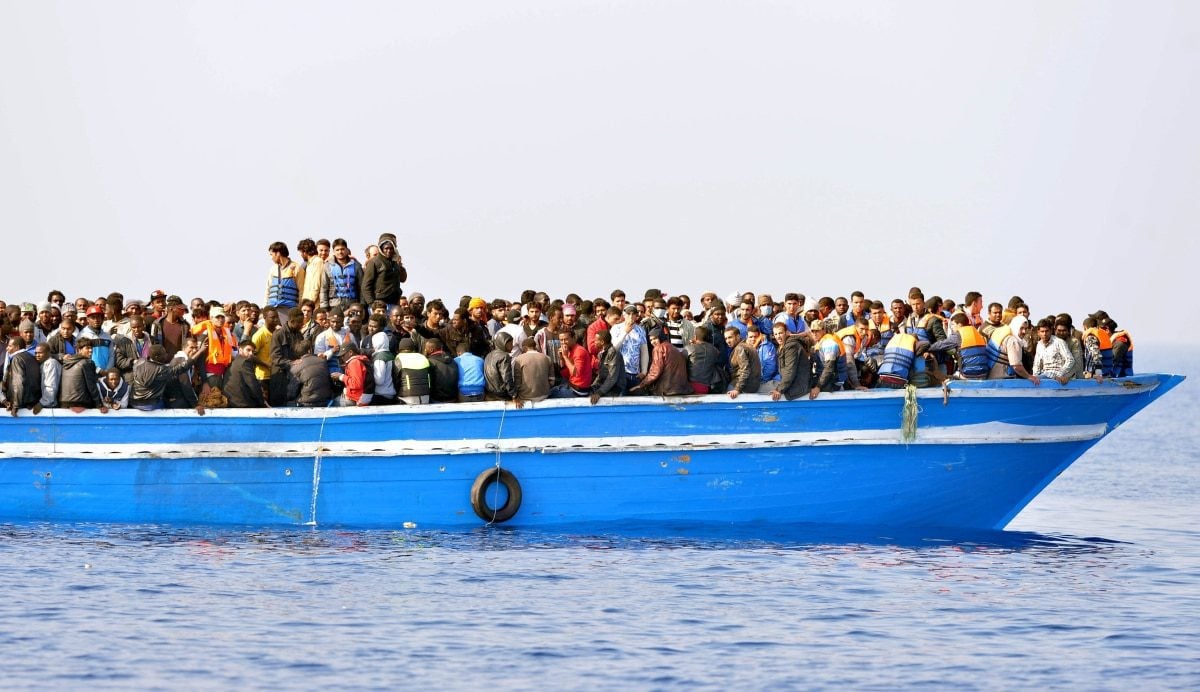 Migrants stranded on a boat, thirty miles off the Libyan coast as they are rescued by Royal Marines. PRESS ASSOCIATION Photo. Picture date: Sunday June 7, 2015. The rescued migrants were taken to the Royal Navy ship where they were searched and processed before being handed over to the Italian authorities. Britain is a country that 